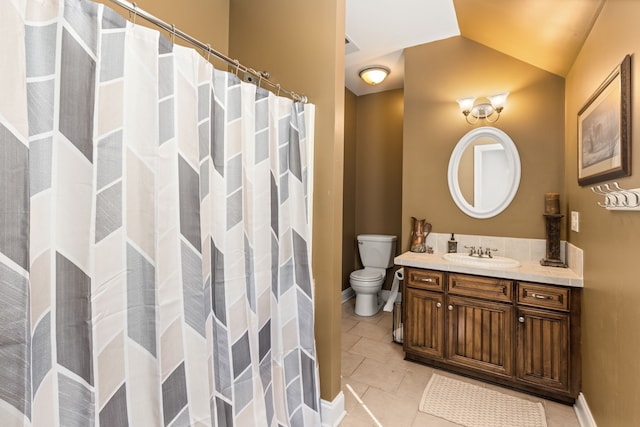 bathroom with curtained shower, vanity, toilet, and tile patterned floors