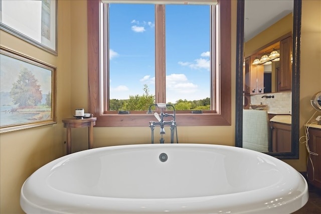 bathroom featuring vanity and a tub