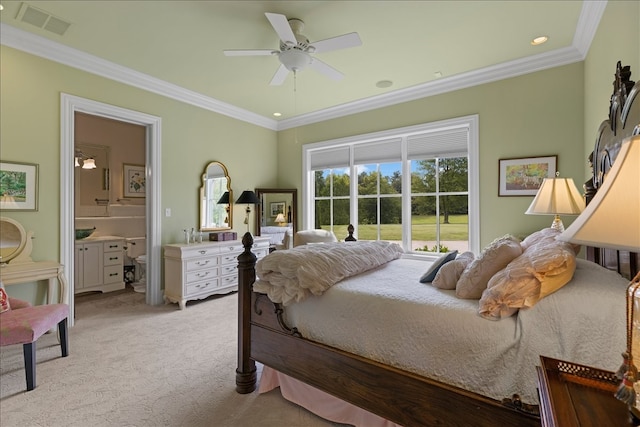 carpeted bedroom with ensuite bath, crown molding, and ceiling fan