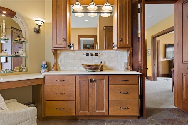 bathroom with vanity, tasteful backsplash, and tile patterned flooring