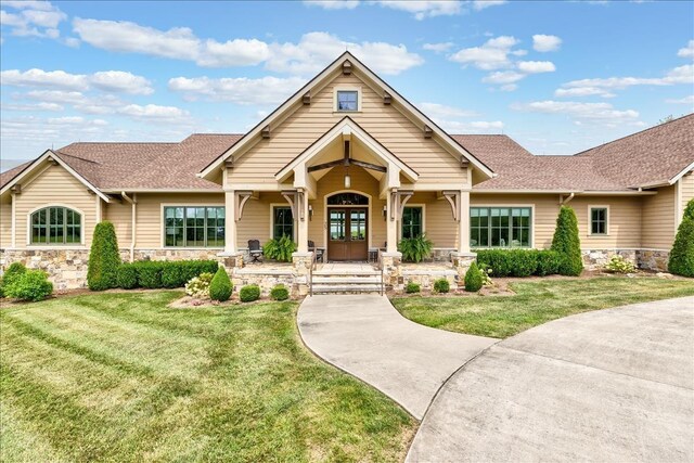 craftsman-style home featuring a porch and a front lawn