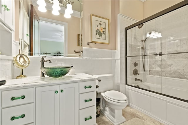 full bathroom featuring vanity, toilet, backsplash, and tile walls