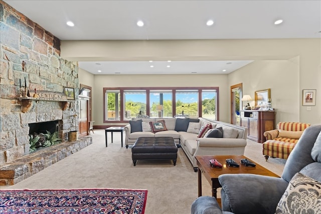 living room featuring light colored carpet, a fireplace, and plenty of natural light