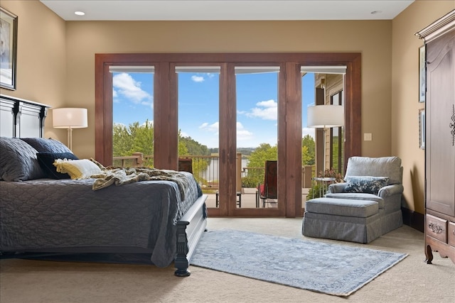 carpeted bedroom featuring access to outside