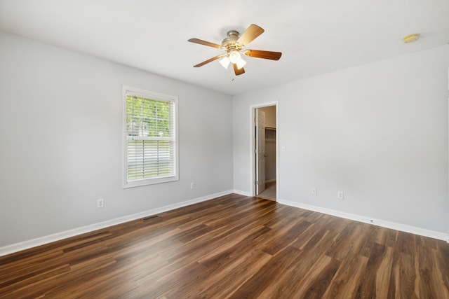 empty room featuring ceiling fan and dark hardwood / wood-style floors