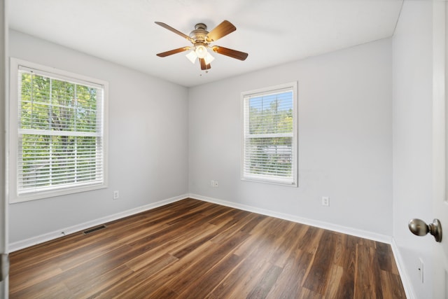 unfurnished room with ceiling fan and dark hardwood / wood-style floors