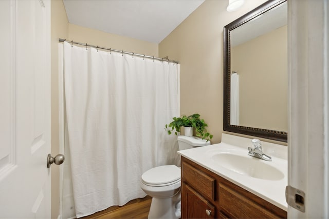 bathroom with vanity, toilet, hardwood / wood-style flooring, and curtained shower