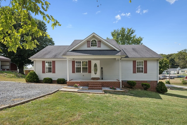 view of front of property with covered porch and a front lawn