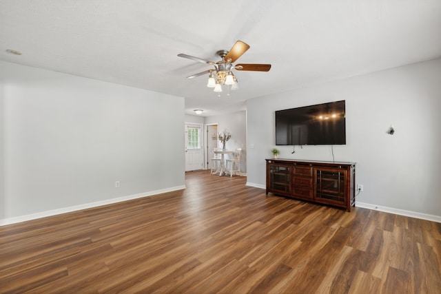 unfurnished living room with ceiling fan and dark hardwood / wood-style floors