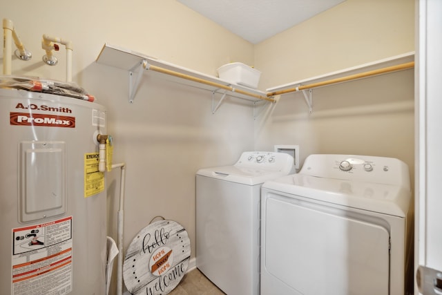 washroom with washer and clothes dryer and electric water heater