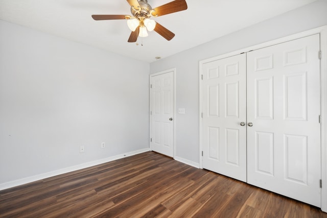 unfurnished bedroom featuring ceiling fan, dark hardwood / wood-style floors, and a closet