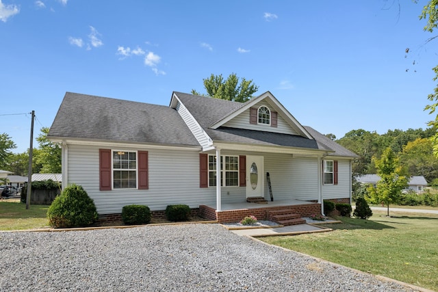 view of front of property with a front yard and covered porch