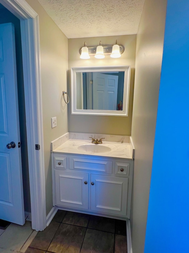 bathroom featuring vanity, a textured ceiling, and tile patterned flooring