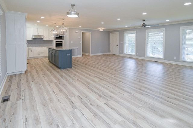 kitchen featuring visible vents, white cabinetry, and open floor plan