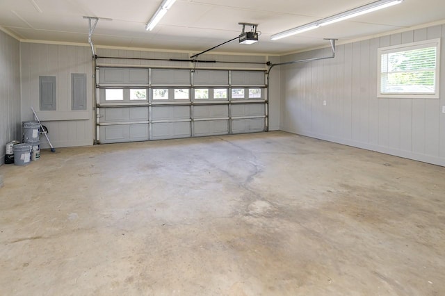 garage with electric panel and a garage door opener