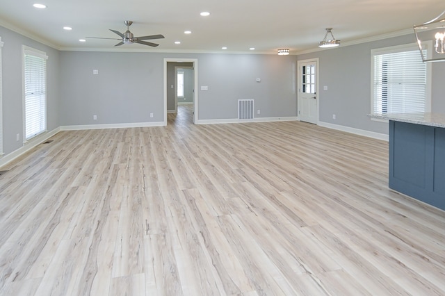 unfurnished living room with ceiling fan, crown molding, and light hardwood / wood-style flooring