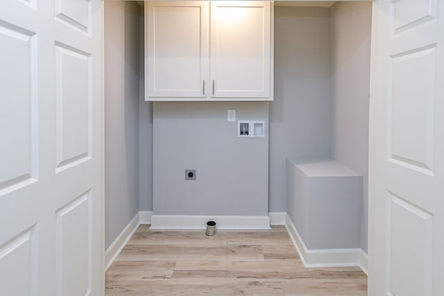 washroom featuring light hardwood / wood-style flooring, cabinets, washer hookup, and hookup for an electric dryer