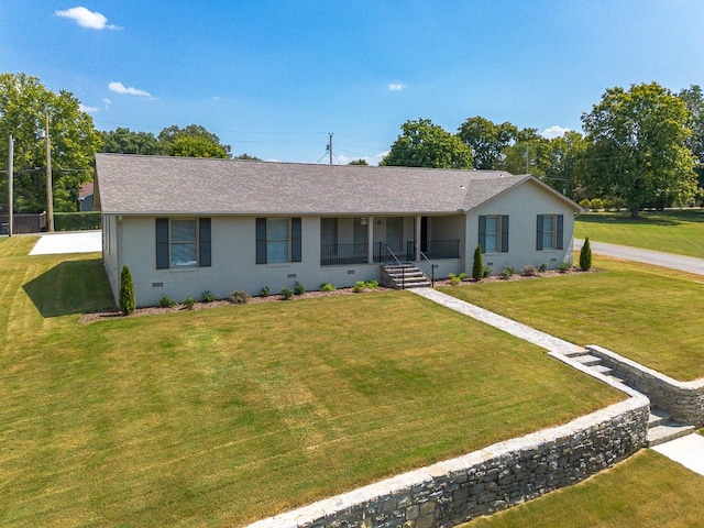 ranch-style house featuring a front yard, brick siding, roof with shingles, and crawl space