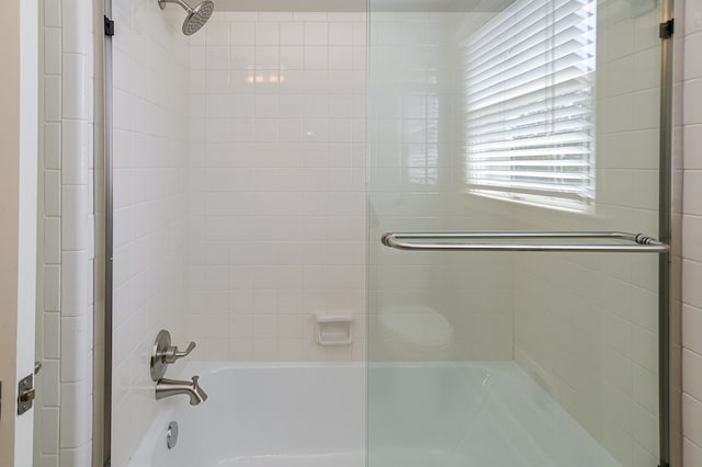 bathroom featuring shower / bath combination with glass door