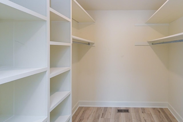 walk in closet featuring visible vents and wood finished floors