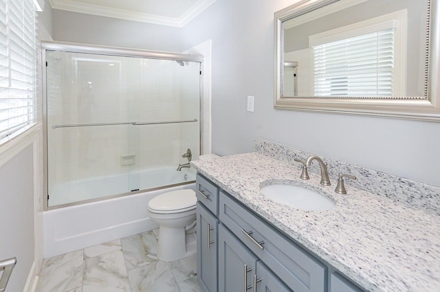 bathroom featuring vanity, ornamental molding, marble finish floor, toilet, and combined bath / shower with glass door