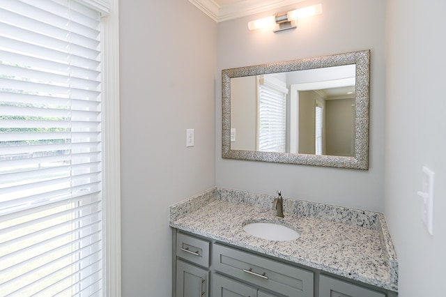 bathroom featuring crown molding, vanity, and a wealth of natural light