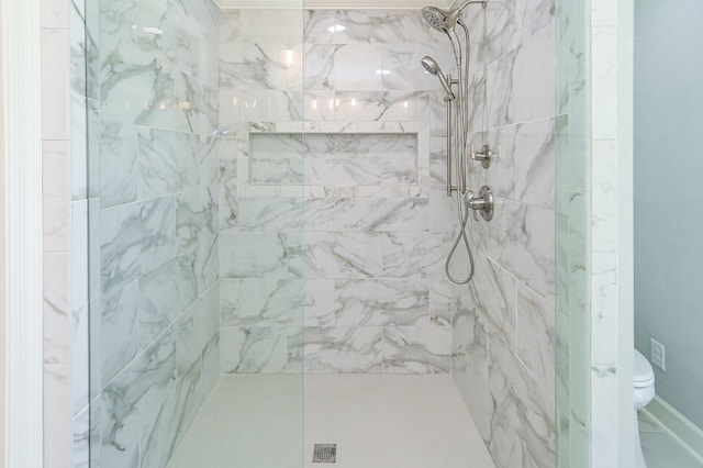 bathroom featuring toilet and tiled shower