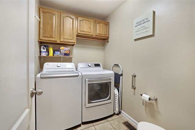 washroom with light tile patterned floors, cabinets, and independent washer and dryer