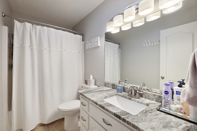 bathroom with tile patterned floors, walk in shower, toilet, vanity, and a textured ceiling