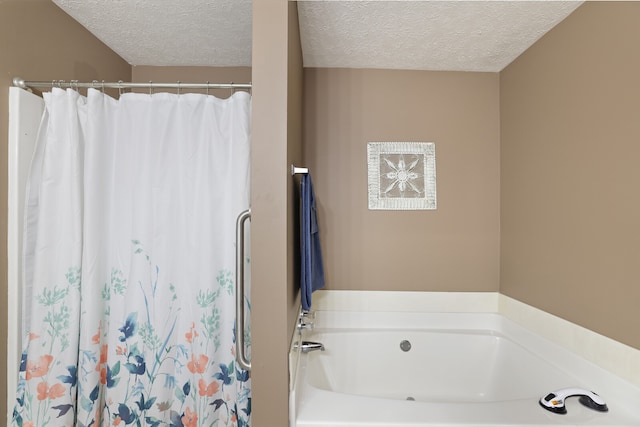 bathroom with separate shower and tub and a textured ceiling