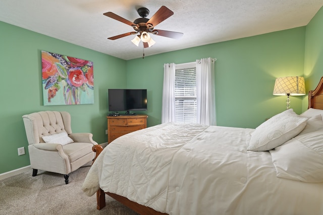 carpeted bedroom with a textured ceiling and ceiling fan