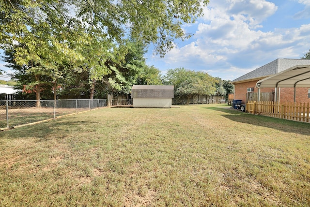 view of yard featuring a storage shed and a carport