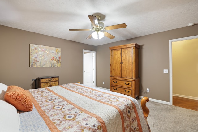 bedroom featuring a textured ceiling, wood-type flooring, and ceiling fan