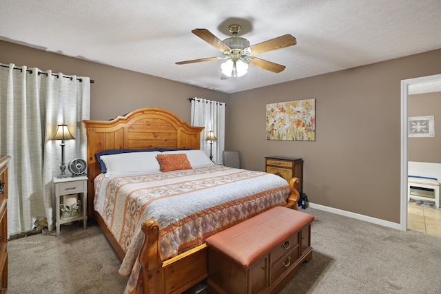 bedroom featuring carpet flooring, ceiling fan, and a textured ceiling