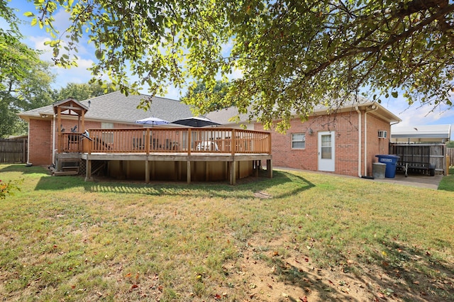 back of property featuring a yard, a patio, and a deck