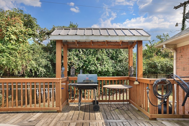 deck with area for grilling and a gazebo