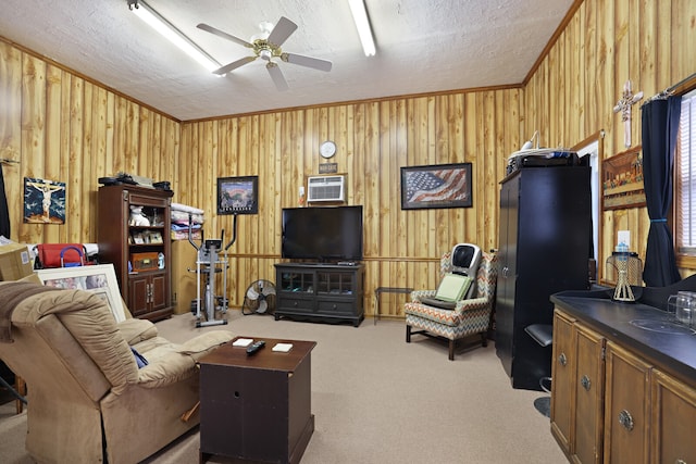 living room with a textured ceiling, ceiling fan, ornamental molding, and carpet floors