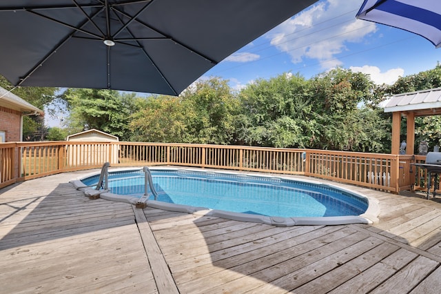 view of pool featuring a wooden deck and a gazebo