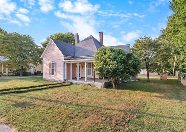 view of front of property with a front lawn and a chimney