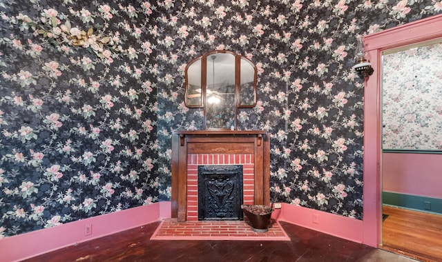 interior details with wallpapered walls, a fireplace, and wood finished floors