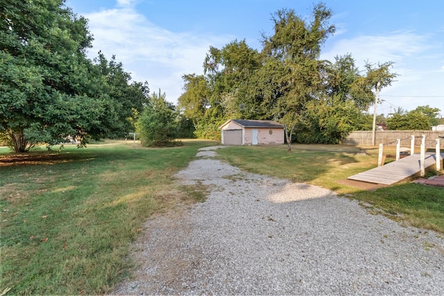 view of yard featuring an outbuilding and a detached garage