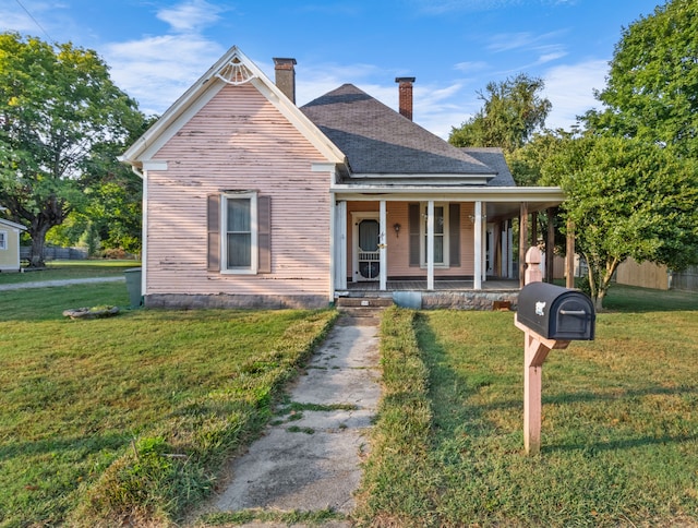 bungalow-style home featuring covered porch and a front yard