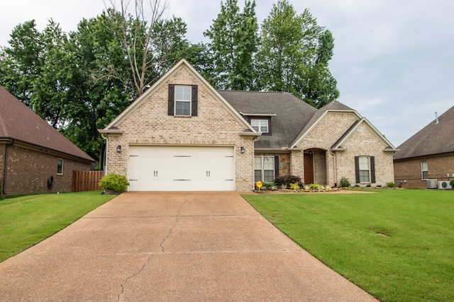 view of front of property with a garage and a front yard