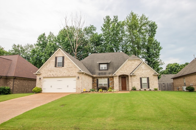 view of front of house featuring a garage and a front yard