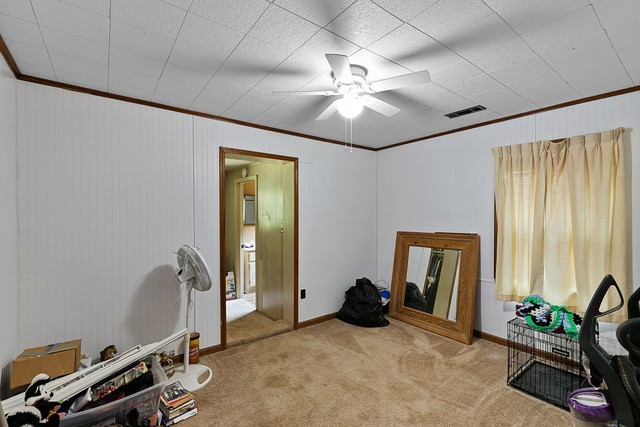 misc room featuring ceiling fan, ornamental molding, and light carpet