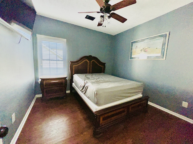 bedroom with ceiling fan and dark wood-type flooring