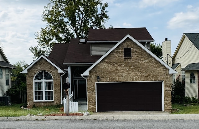 view of front facade featuring cooling unit and a garage