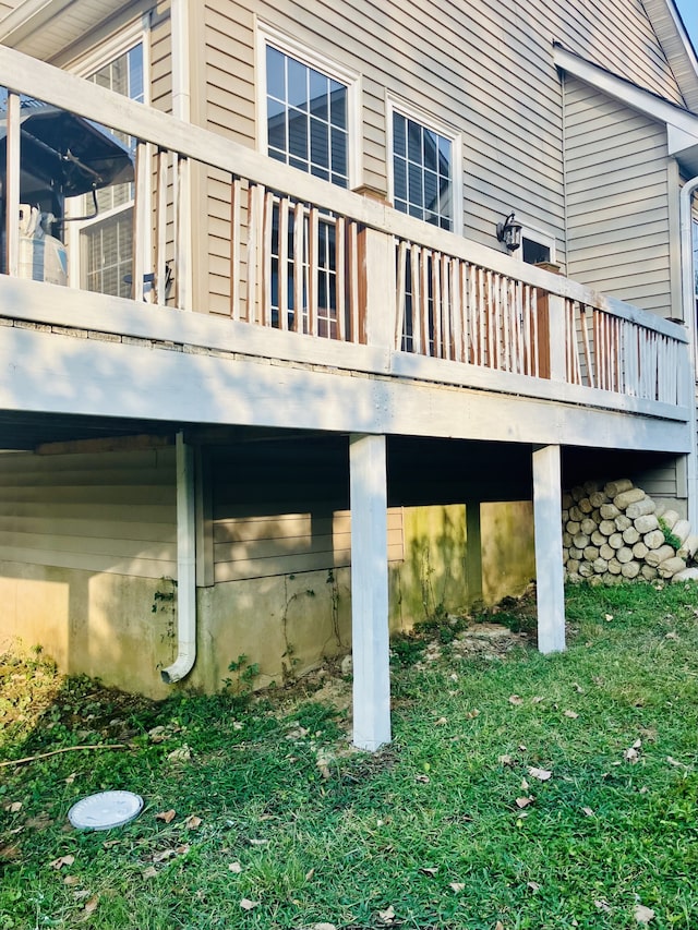 view of home's exterior featuring a lawn and a deck