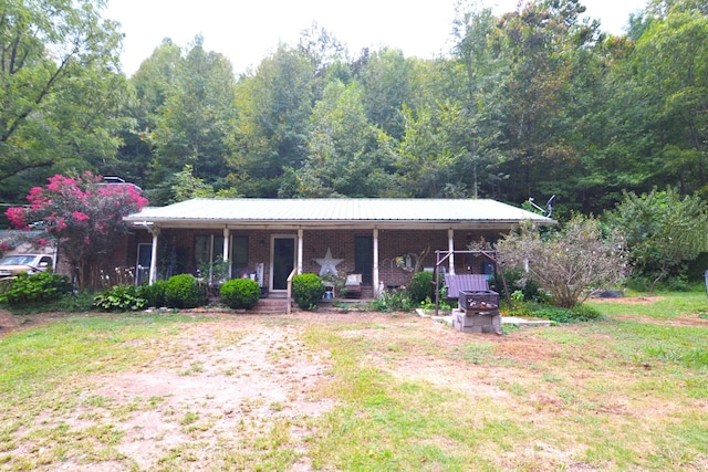 555 Myrick Branch Rd, Pulaski, TN 38478 - single story home featuring covered porch, brick siding, and a wooded view