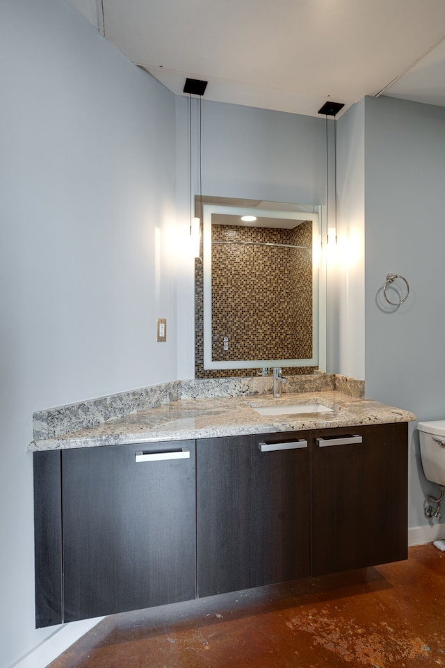 bathroom featuring a shower, toilet, and vanity